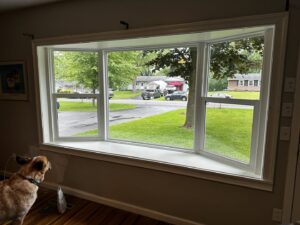 Interior view of a newly installed bay window with fresh trim, completed by Pink Rose Home Service in Rochester, NY.