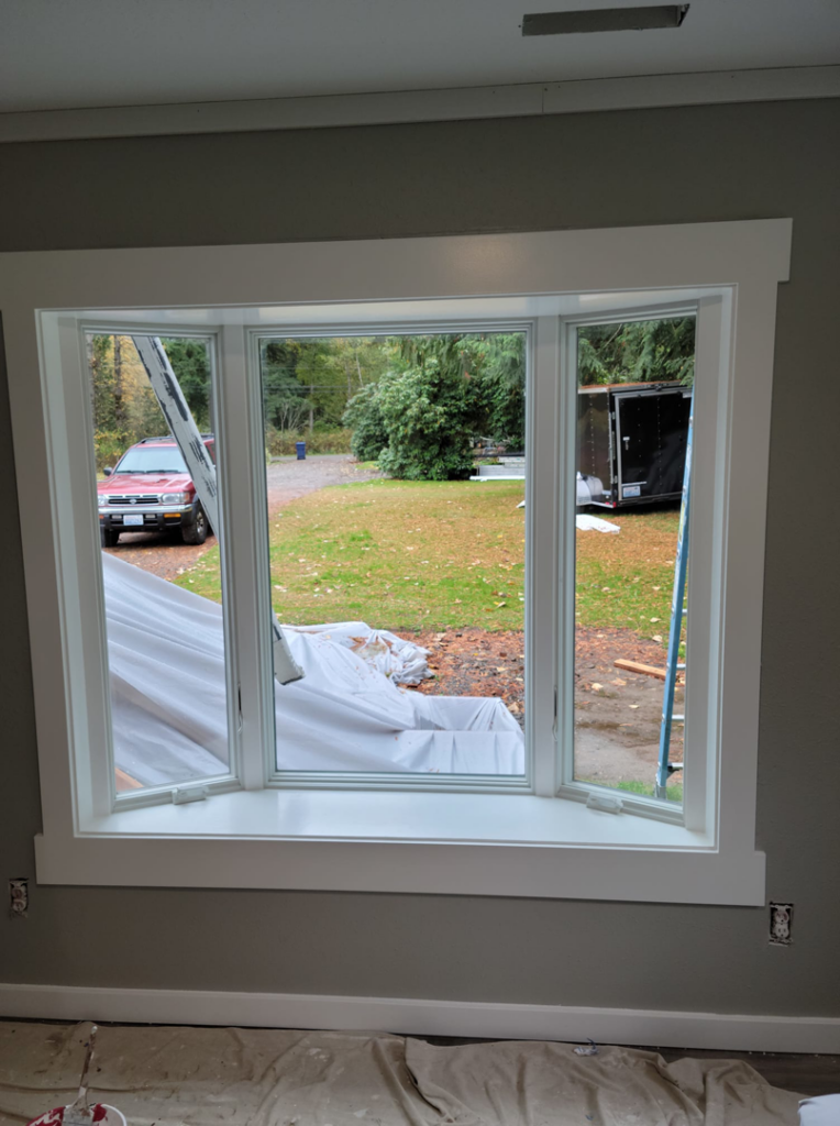 A newly installed bay window with white trim, completed by Smith Finishes LLC in Everett, WA.