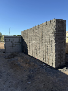 A new block wall under construction with rebar reinforcement by Milflores King Construction LLC in Glendale, AZ