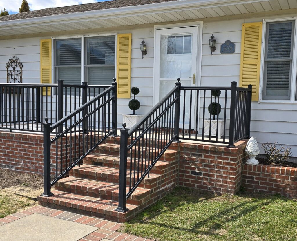 New brick steps with black metal railings installed by M. Phippin Contracting in Hebron, MD.
