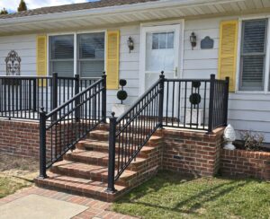 New brick steps with black metal railings installed by M. Phippin Contracting in Hebron, MD.