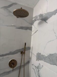 Close-up of a new bronze shower head and matching fixtures installed by Castillejo Handyman Services in San Diego, CA