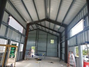 Interior view of a new building under construction with metal framing and high ceilings by Belair Inc. in Saint Cloud, FL
