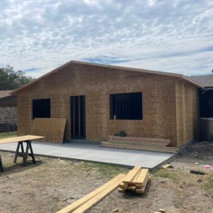 A new building under construction with plywood sheathing, showcasing general contractor work by M.M. Remodelers in Resaca, GA.
