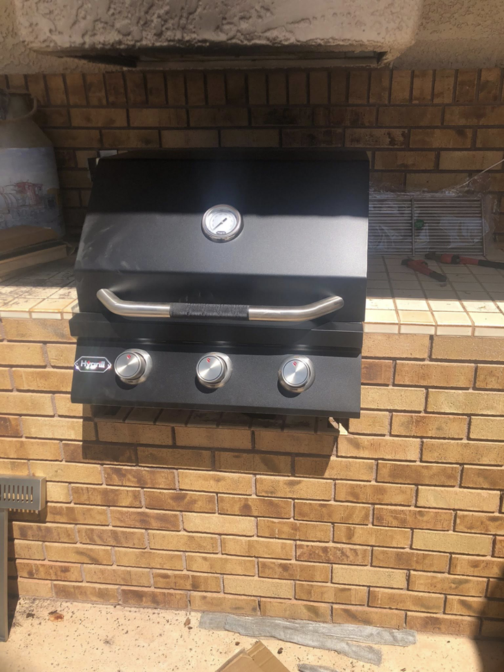 A newly installed built-in grill in an outdoor kitchen by Mancusi Home Maintenance in Boulder City, NV.