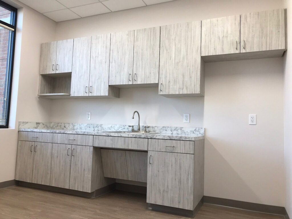 Newly installed cabinets and sink in a modern kitchenette by Pharos Contracting Company Inc., a handyman service in Newark, NJ