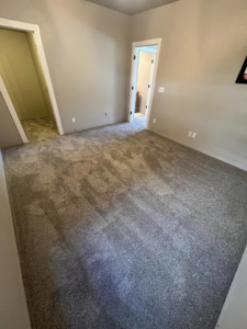 A bedroom with new carpet installed by Elite Flooring Professionals in Pueblo, CO.