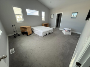 A room with newly installed carpet and some furniture by JJ's Handyman Service in Las Vegas, NV
