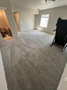 A spacious living room with new carpet installed by Elite Flooring Professionals in Pueblo, CO.