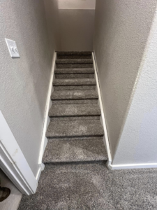 A newly installed carpeted staircase by Elite Flooring Professionals in Pueblo, CO.