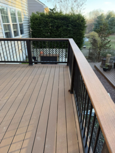 A newly installed composite deck with sleek black railings by Harris Home Creations in Philadelphia, PA.