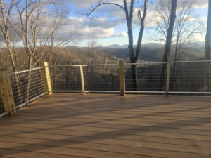 A newly installed composite deck with modern cable railing by American Cable & Rigging in Mills River, NC.