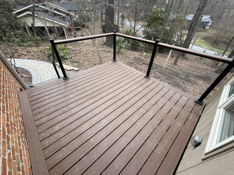 A newly built composite deck with modern cable railings by IWork Home Services in Greensboro, NC.