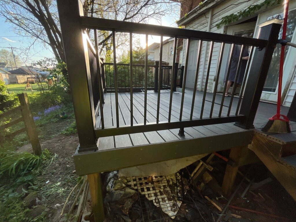 A view of a newly constructed composite deck with black railings, showcasing work by The Golden Touch handyman services in Huntington, WV.
