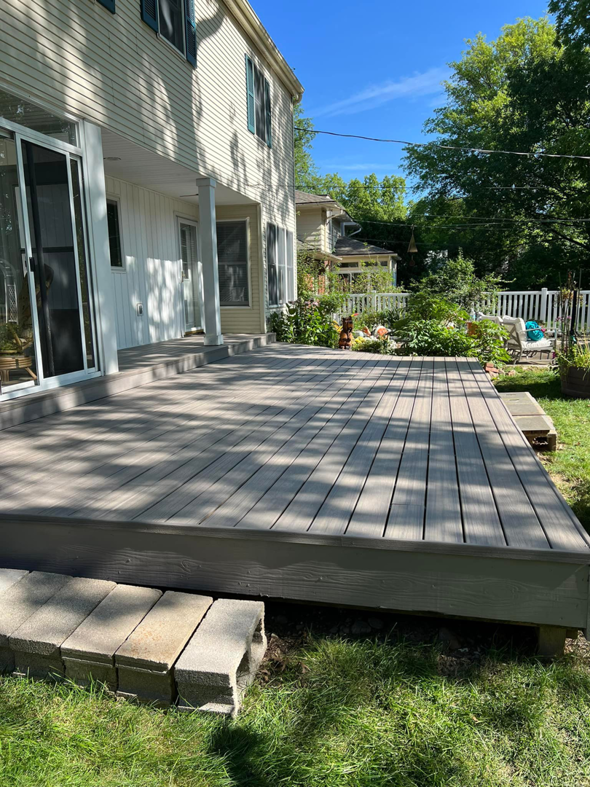 A newly built composite deck attached to a house, completed by Do It All Contracting in Rochester, NY.