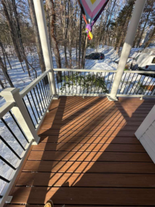 A newly installed composite deck with white railings, showcasing quality handyman work by Remodel or Renew Home Improvement in Worcester, MA.