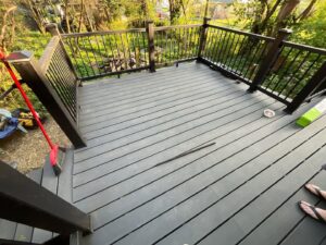 A newly installed composite deck with black railings, a project completed by The Golden Touch handyman services in Huntington, WV.