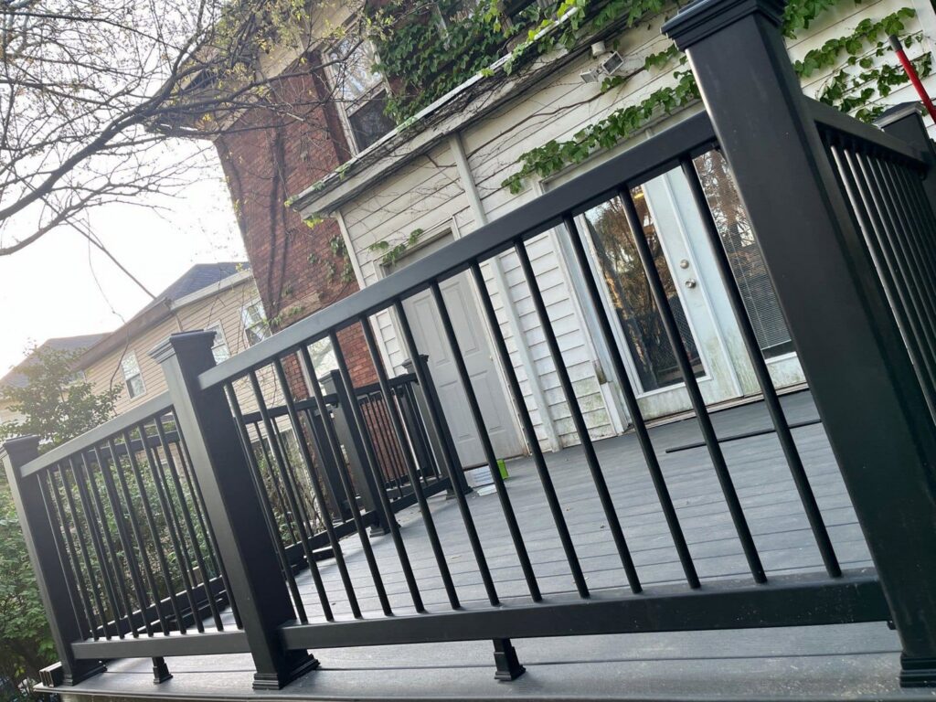 Close-up of newly installed black railings on a composite deck by The Golden Touch handyman services in Huntington, WV.
