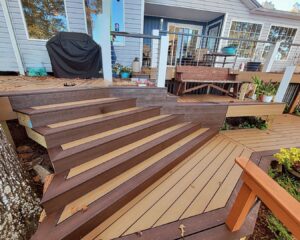 A newly built composite deck with multi-toned stairs by American Custom Exteriors in North Charleston, SC.