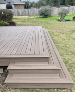 A newly constructed composite deck with multiple steps leading to a backyard, built by RJS Custom Decks in Cibolo, TX.