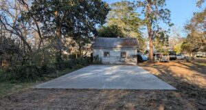 A newly poured concrete pad in a backyard, installed by Allen's Concrete Finishing in Rock Hill, SC.