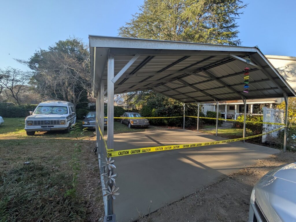 A newly poured concrete slab under a carport, completed by Allen's Concrete Finishing in Rock Hill, SC.
