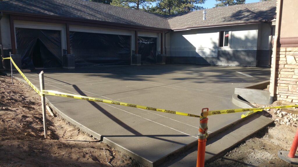 A newly poured concrete driveway and patio area by Element Construction Company in Colorado Springs, CO.