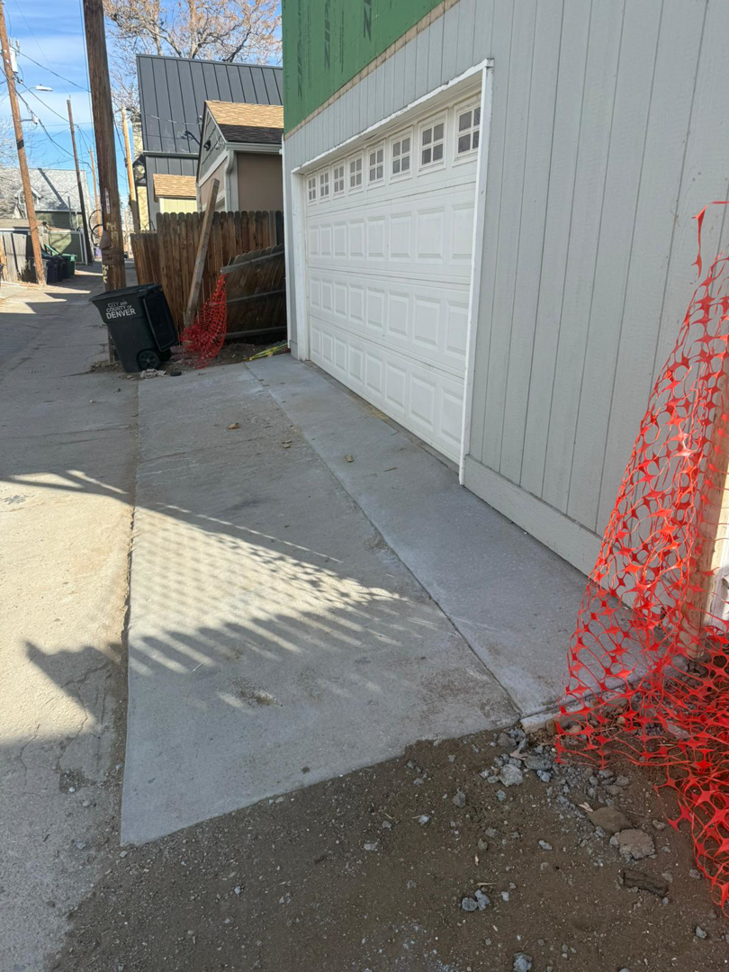 Newly poured concrete driveway and garage door installation by Alex Home Pro Colorado in Denver, CO