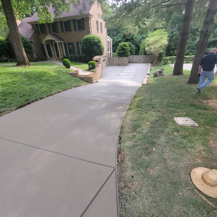 A newly installed concrete driveway by Swift Remodeling South in Charlotte, NC.