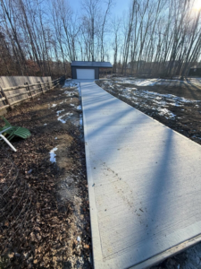 A newly poured concrete driveway leading to a pole barn completed by Forward Construction in Florence, KY.