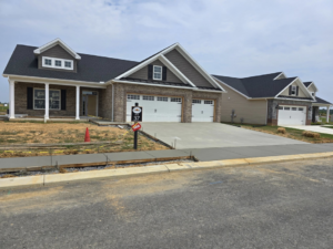 A freshly poured concrete driveway and sidewalk for a new home construction project by J&M Concrete Construction, LLC in Fayetteville, PA.