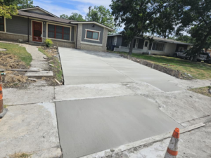 A new concrete driveway and sidewalk section completed by Requena Concrete San Tex in San Antonio, TX