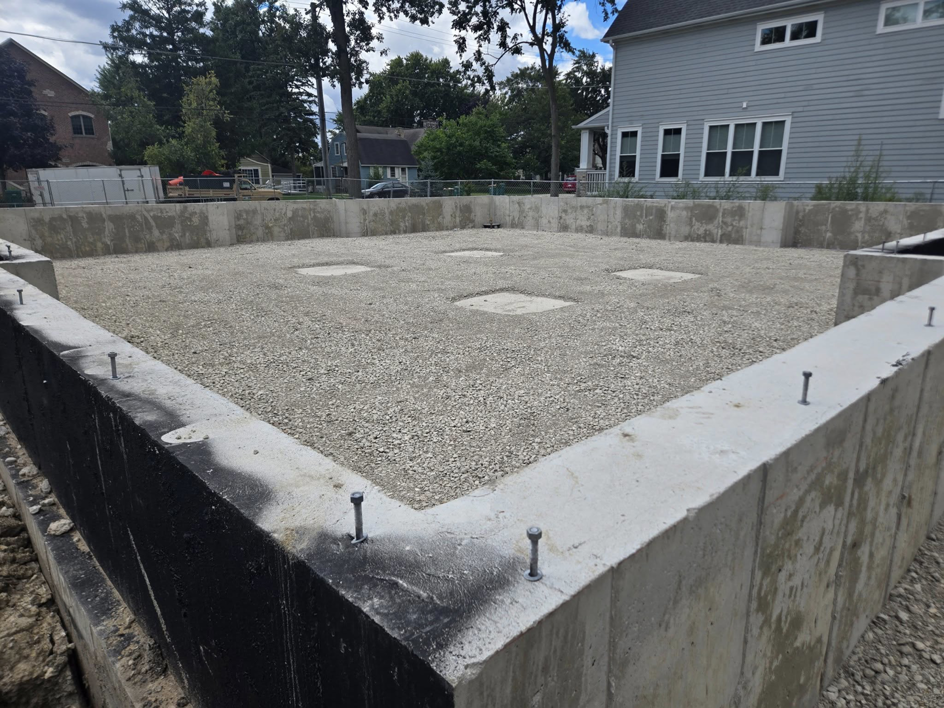 New concrete foundation walls with gravel fill, part of a construction project by Specialized Building Services Inc. in Chicago, IL.