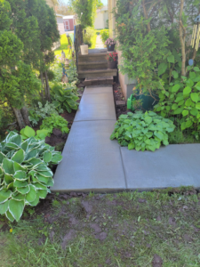 A newly installed concrete pathway leading to a home, completed by Zambrano Concrete in Duluth, MN.