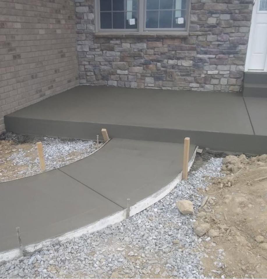 New concrete patio and curved walkway installation by Mudd Brothers Contracting Co. in Pittsburgh, PA.