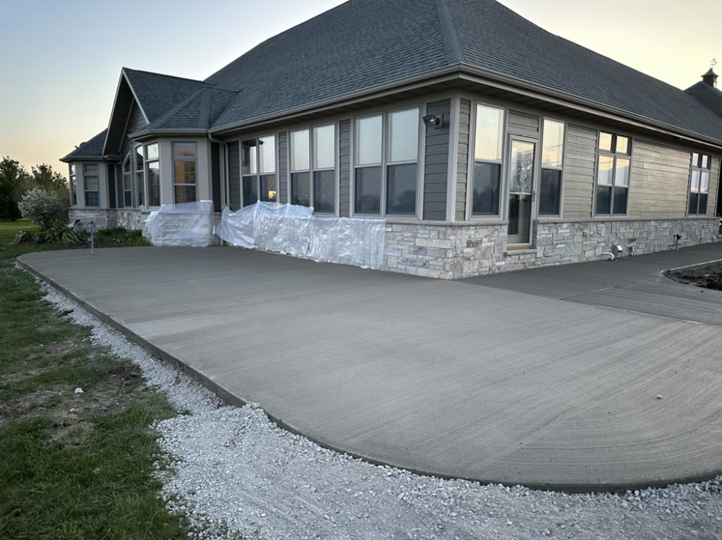A newly poured concrete patio and driveway installed by R&A Concrete Home Solutions LLC in Appleton, WI.