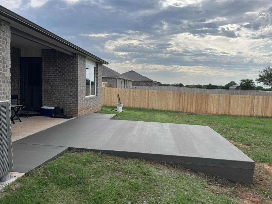 A newly poured concrete patio extension from a house by Power concrete in Thousand Oaks, CA.