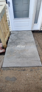 Newly installed concrete ramp and wooden railing after completion by Bernardo Buildings Inc in Virginia Beach, VA.