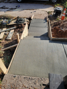 A newly poured concrete ramp or sloped pathway with forms, completed by Zambrano Concrete in Duluth, MN.