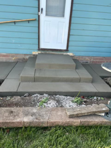 Newly installed concrete steps and a landing leading to a home by Cervantes Concrete Llc in Caledonia, WI.