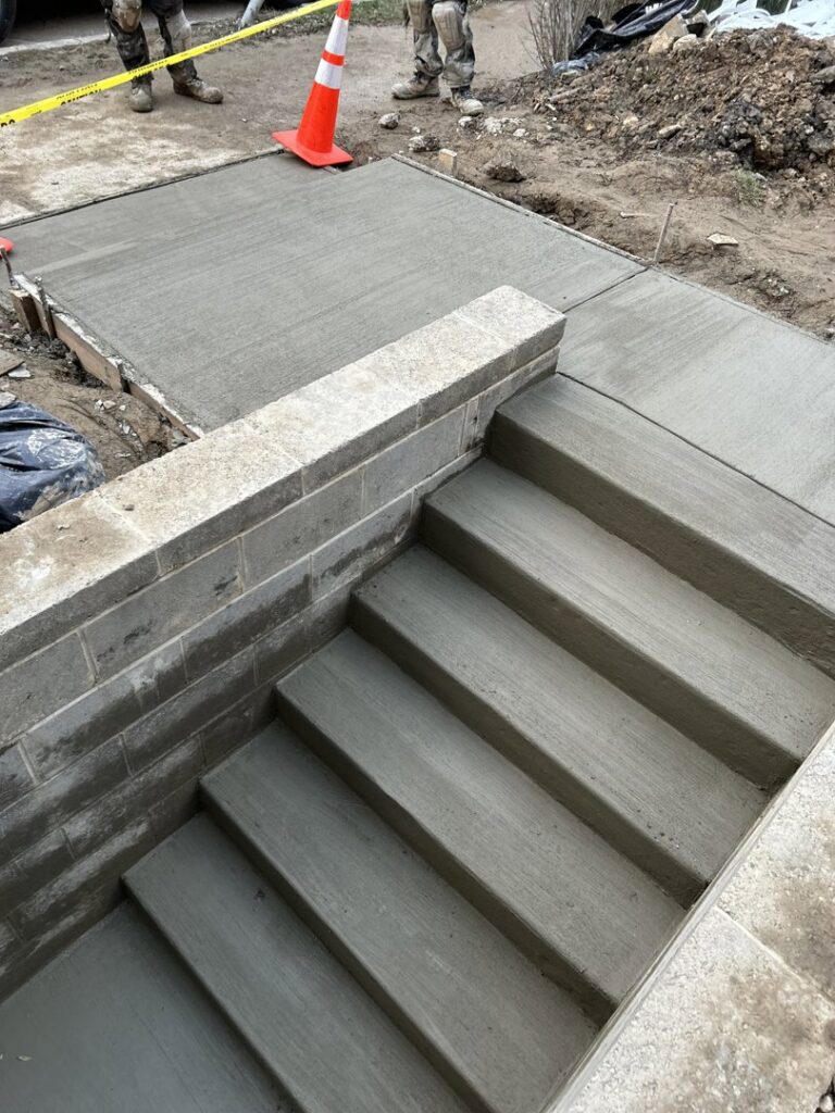 New concrete steps and walkway with cinder block wall by Mudd Brothers Contracting Co. in Pittsburgh, PA.