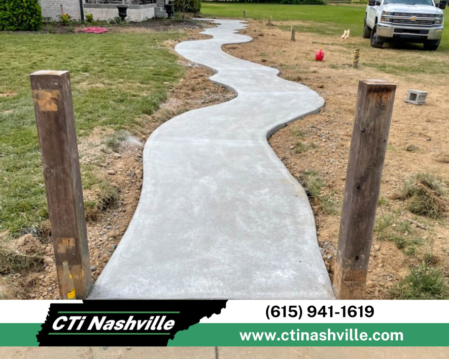 A newly installed concrete winding pathway, showcasing quality craftsmanship by CTi Nashville in Antioch, TN.