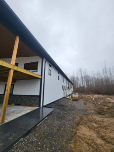 The side of a new construction building featuring a covered patio area by J and R Contracting in Buffalo, NY.
