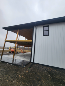 A newly constructed building featuring a covered patio area, demonstrating the work of J and R Contracting in Buffalo, NY.