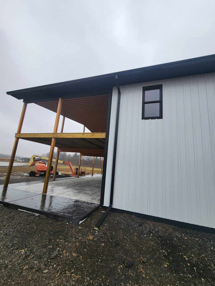 A newly constructed building featuring a covered patio area, demonstrating the work of J and R Contracting in Buffalo, NY.