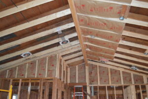 Interior of a new construction building with insulation batts installed in walls and ceiling by ADDICT INSULATION, LLC in St. Charles, MO