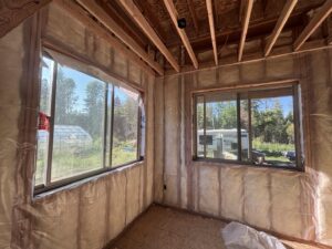 A room under construction with insulation wrap installed on the walls by Pacific Insulation & Mold Remediation in Spokane, WA.