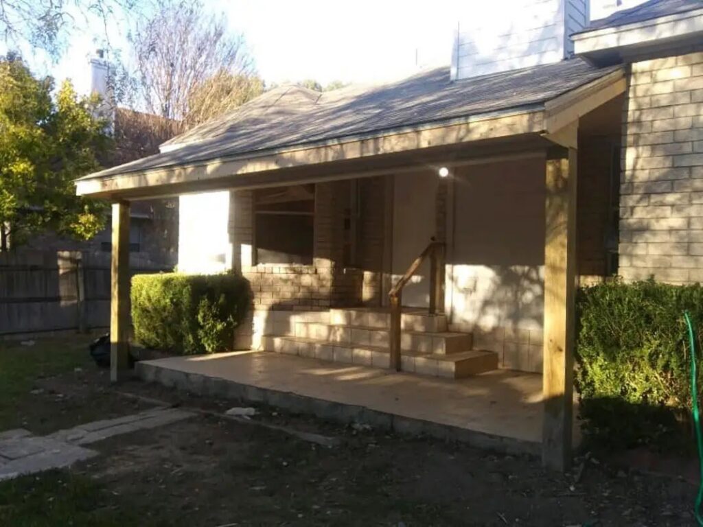 A newly constructed covered front porch for a brick house, built by Morin Construction LLC in San Antonio, TX