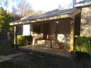 A newly constructed covered front porch for a brick house, built by Morin Construction LLC in San Antonio, TX
