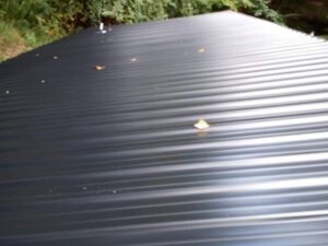 A newly installed dark corrugated metal roof, showcasing roofing services by Huntington Home Repair in Huntington, WV.